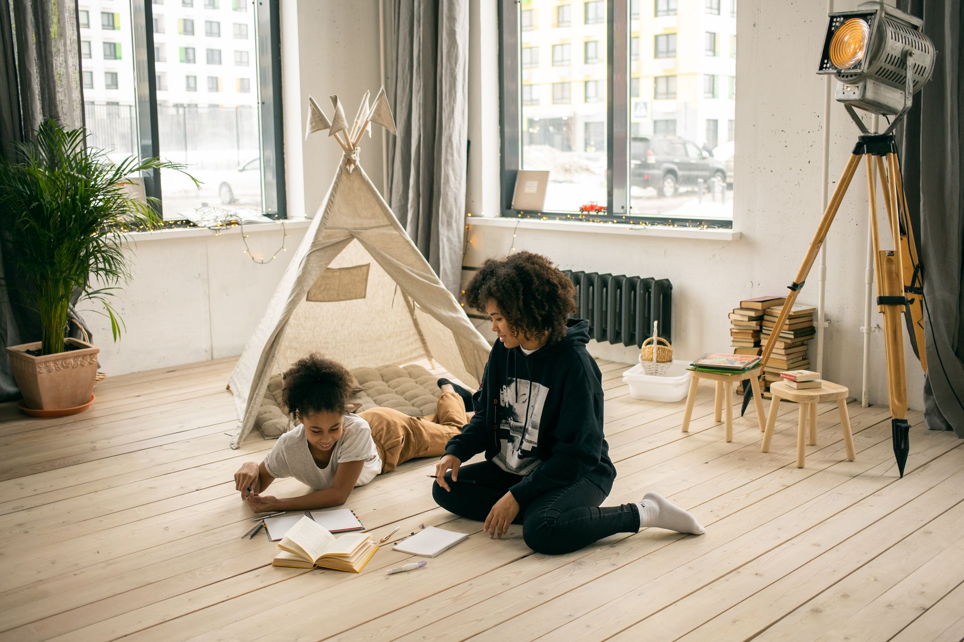 A mother and daughter reading and writing together at home